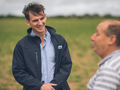 Wessex Water Catchment Management Adviser talking to a farmer in a field
